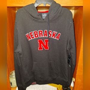 A Colosseum Nebraska Corn Huskers black hoodie in a women's size medium. NWT